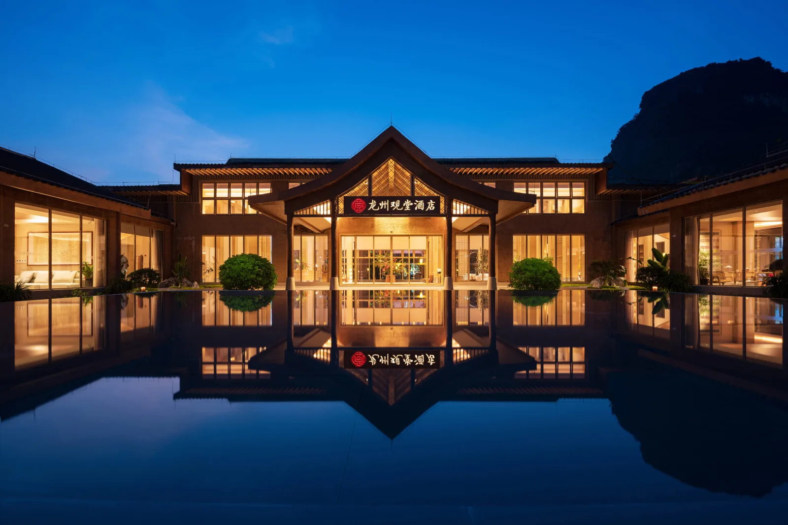 Water garden and entrance of Longzhou Guantang Resort Hotel at night