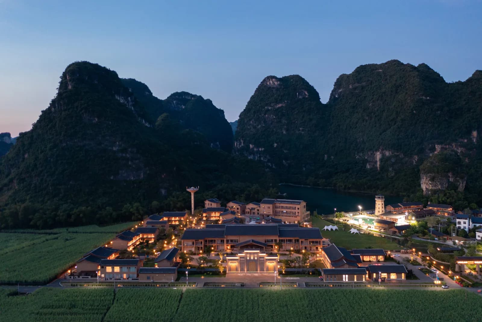 Aerial view of Longzhou Guantang Resort Hotel among sugarcane fields and karst peaks