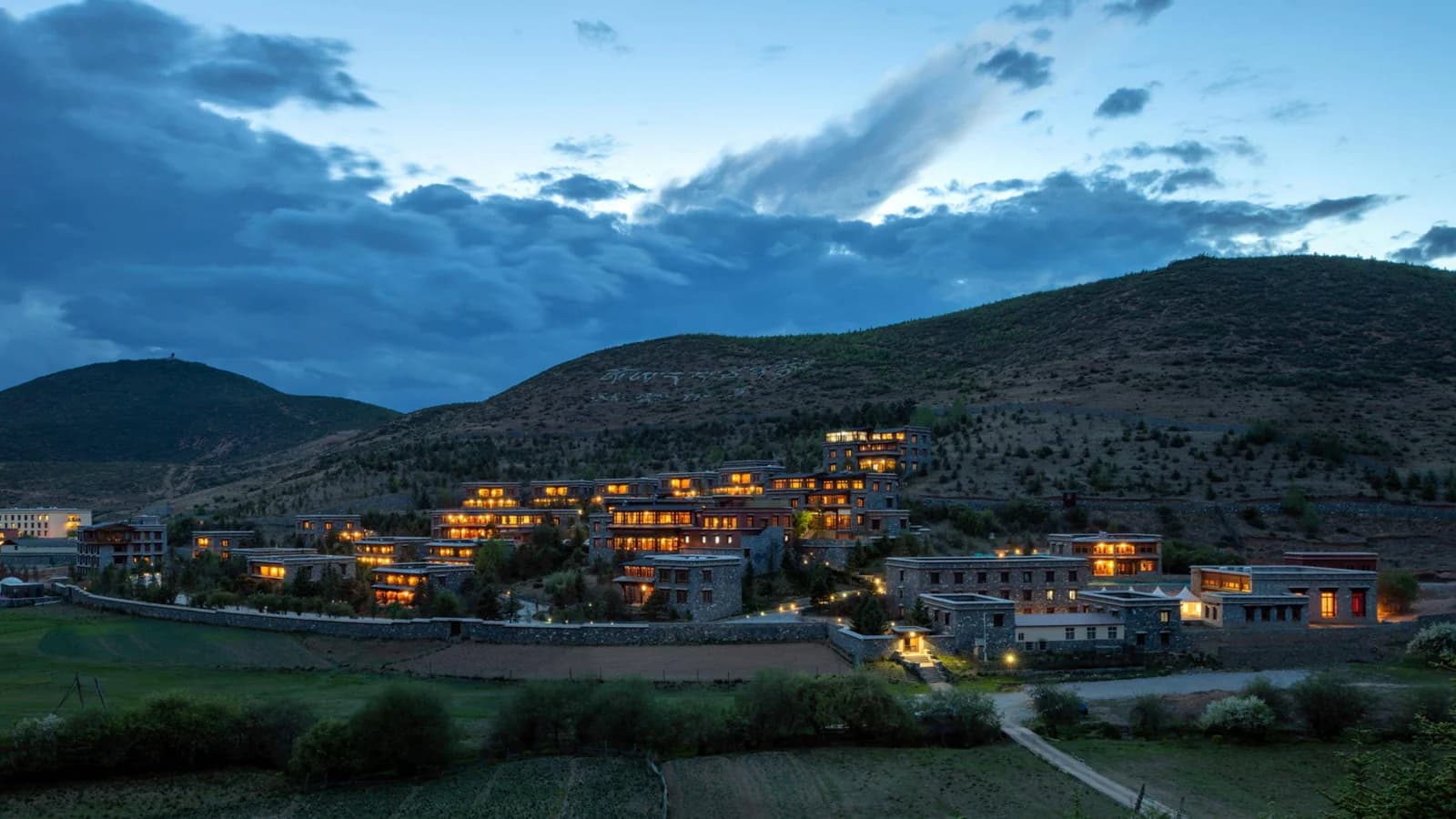 Songtsam Linka Retreat Shangri-La illuminated at dusk